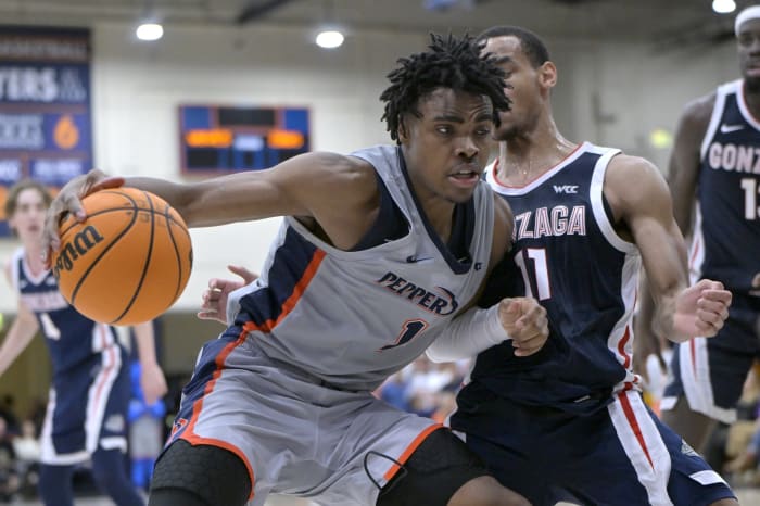 Pepperdine Waves guard Michael Ajayi (1) is defended by Gonzaga Bulldogs guard Nolan Hickman (11) in the second half at Firestone Fieldhouse.